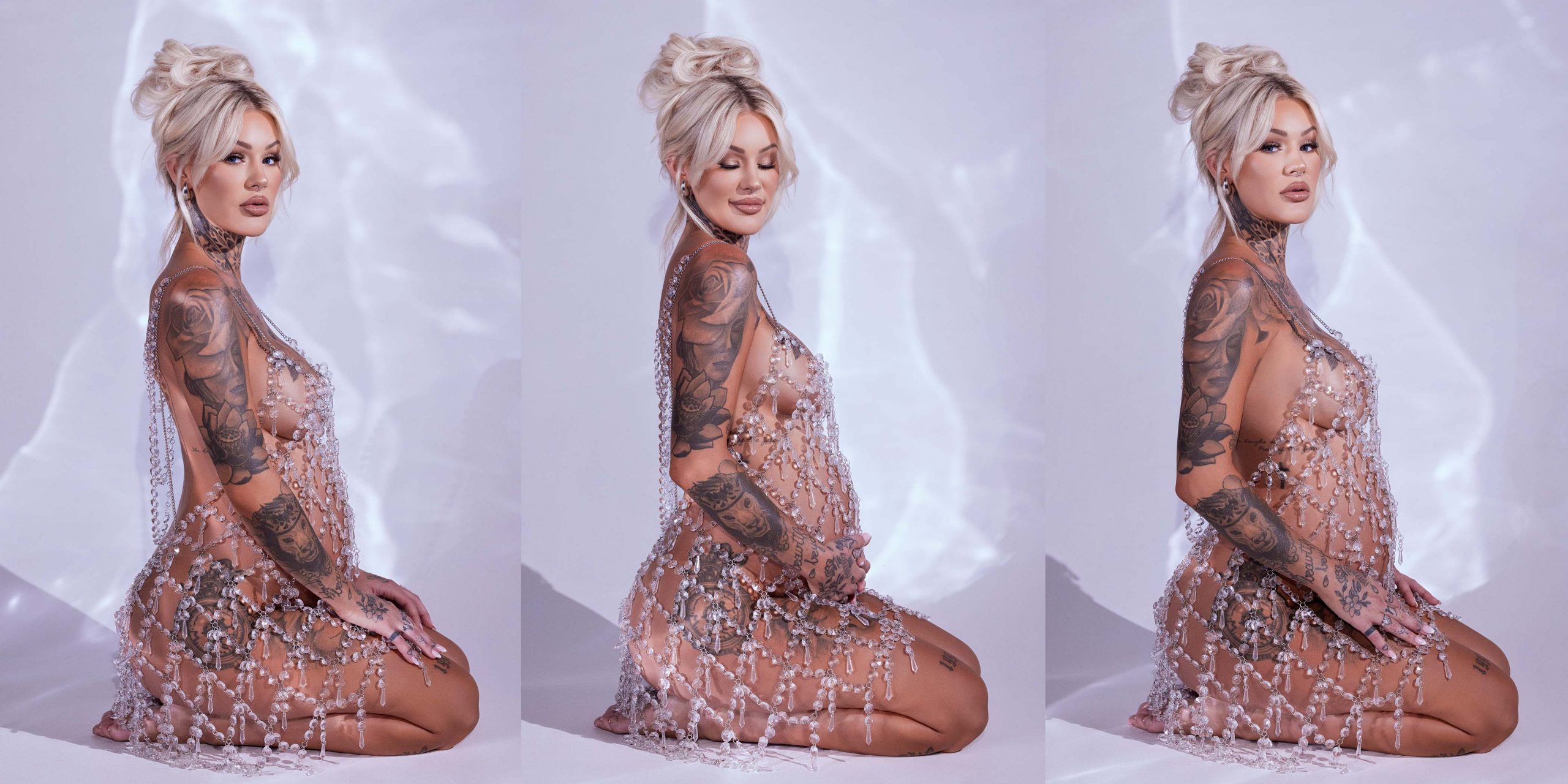 Blonde woman with jeweled dress, pregnant with tattoos